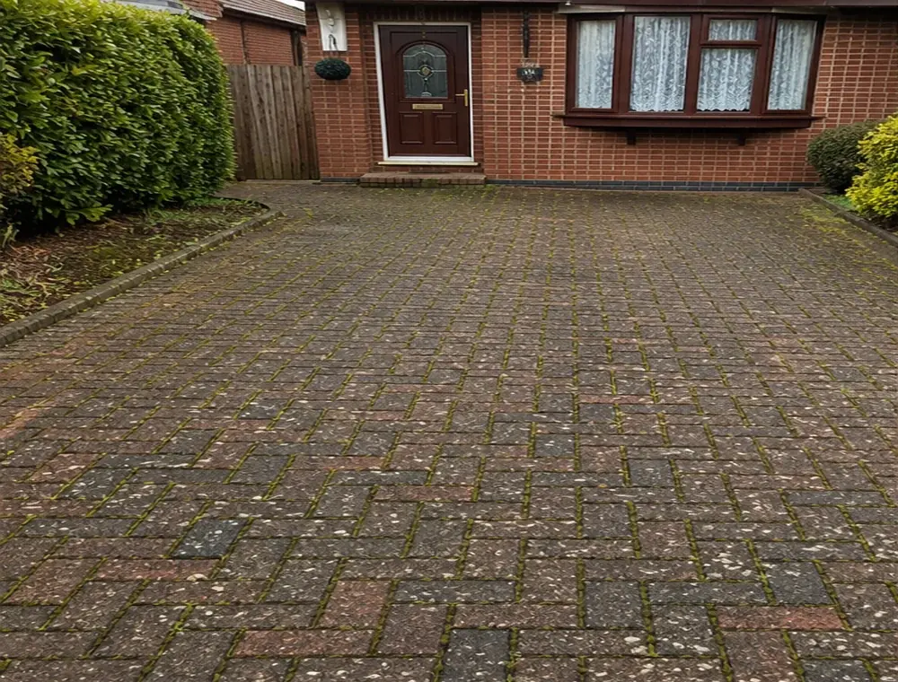 Dirty block paving driveway before cleaning