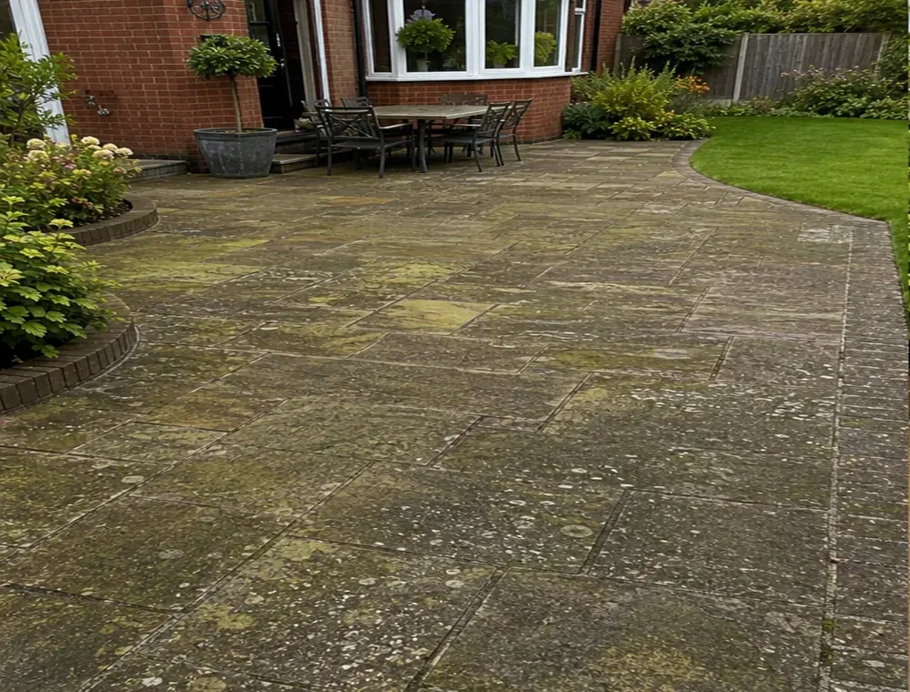 Dirty Indian stone patio before pressure washing in Leigh