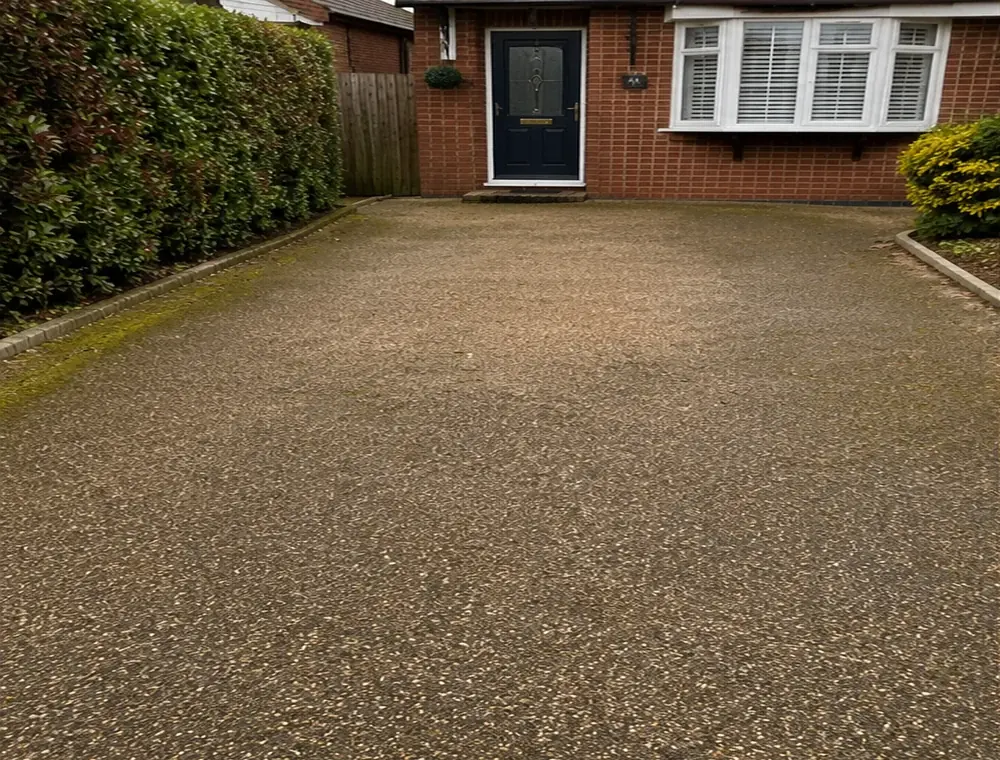Dirty resin driveway before pressure washing